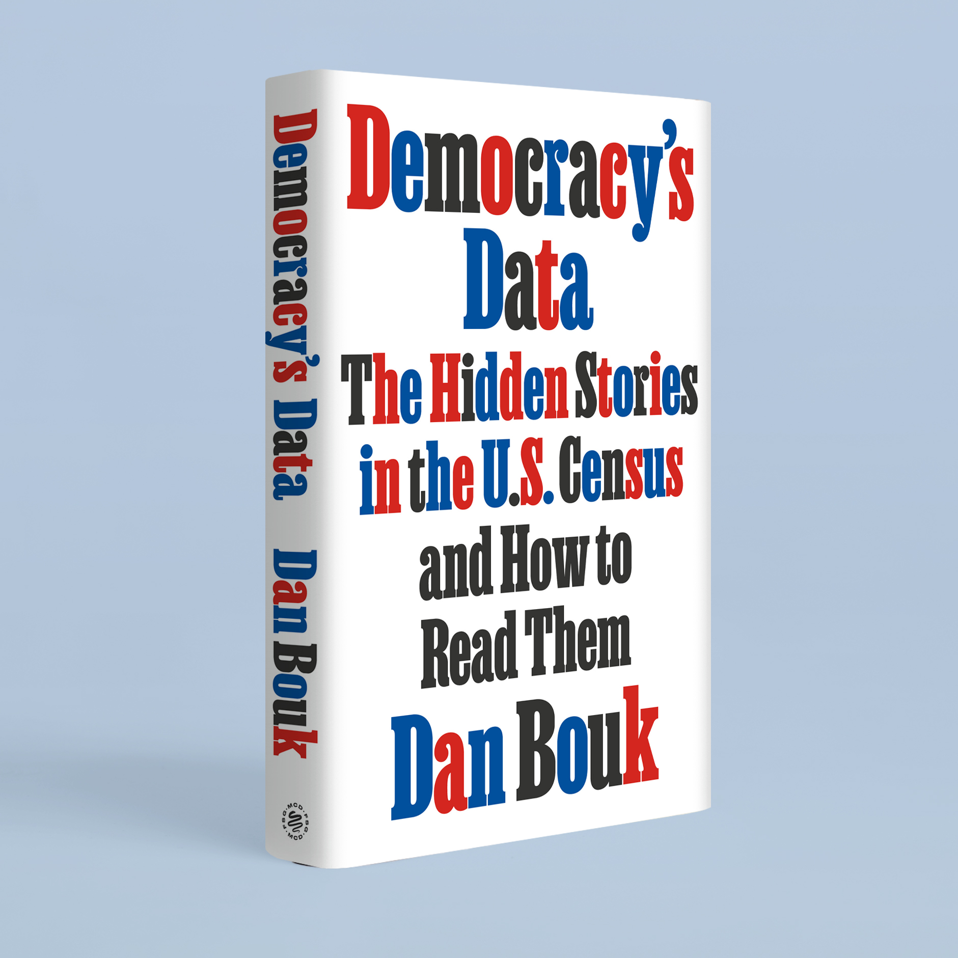 A book stands on edge, against a blue background. The title of the book is in red, blue, and black on a white cover.